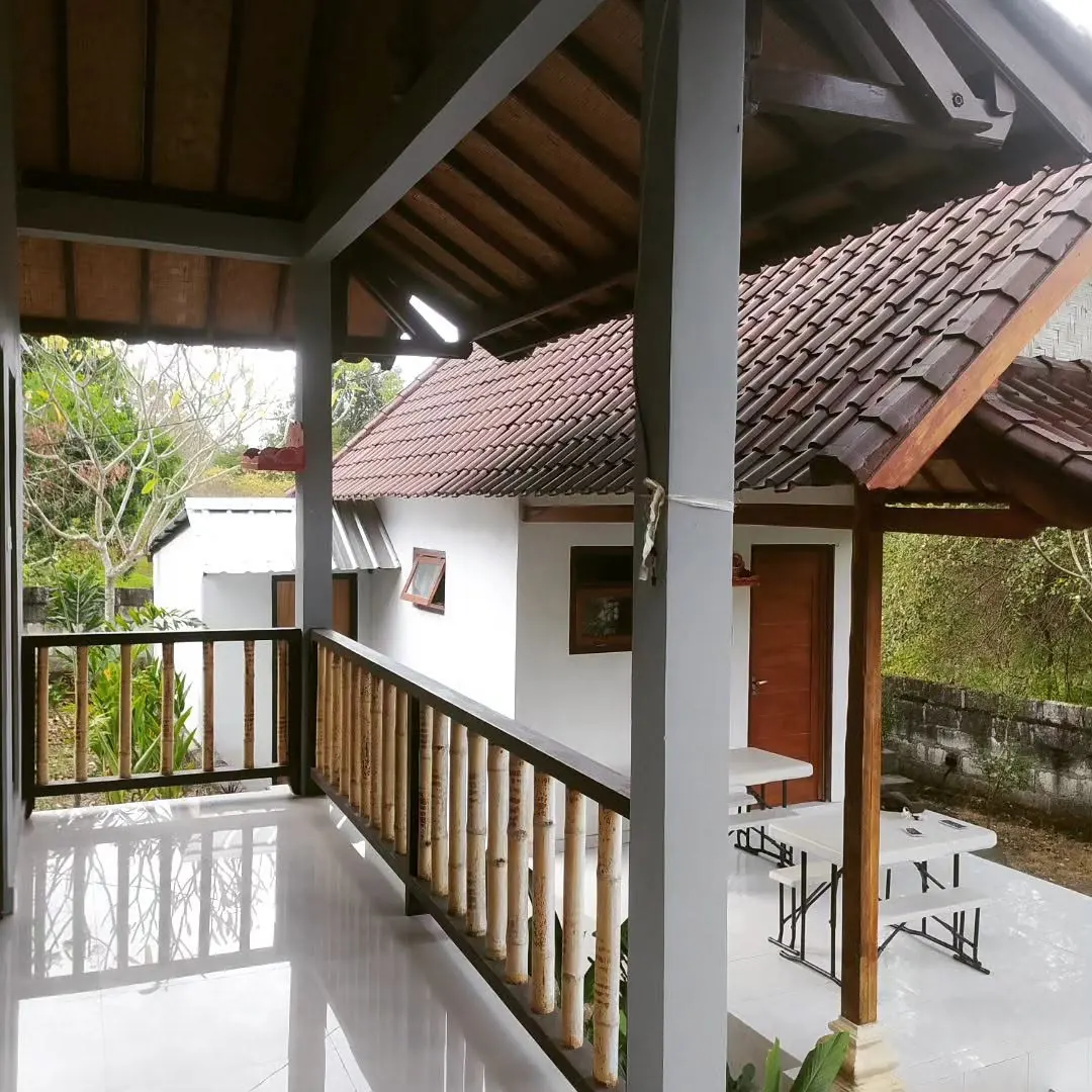 Covered walkway along a veranda with a timber railing
